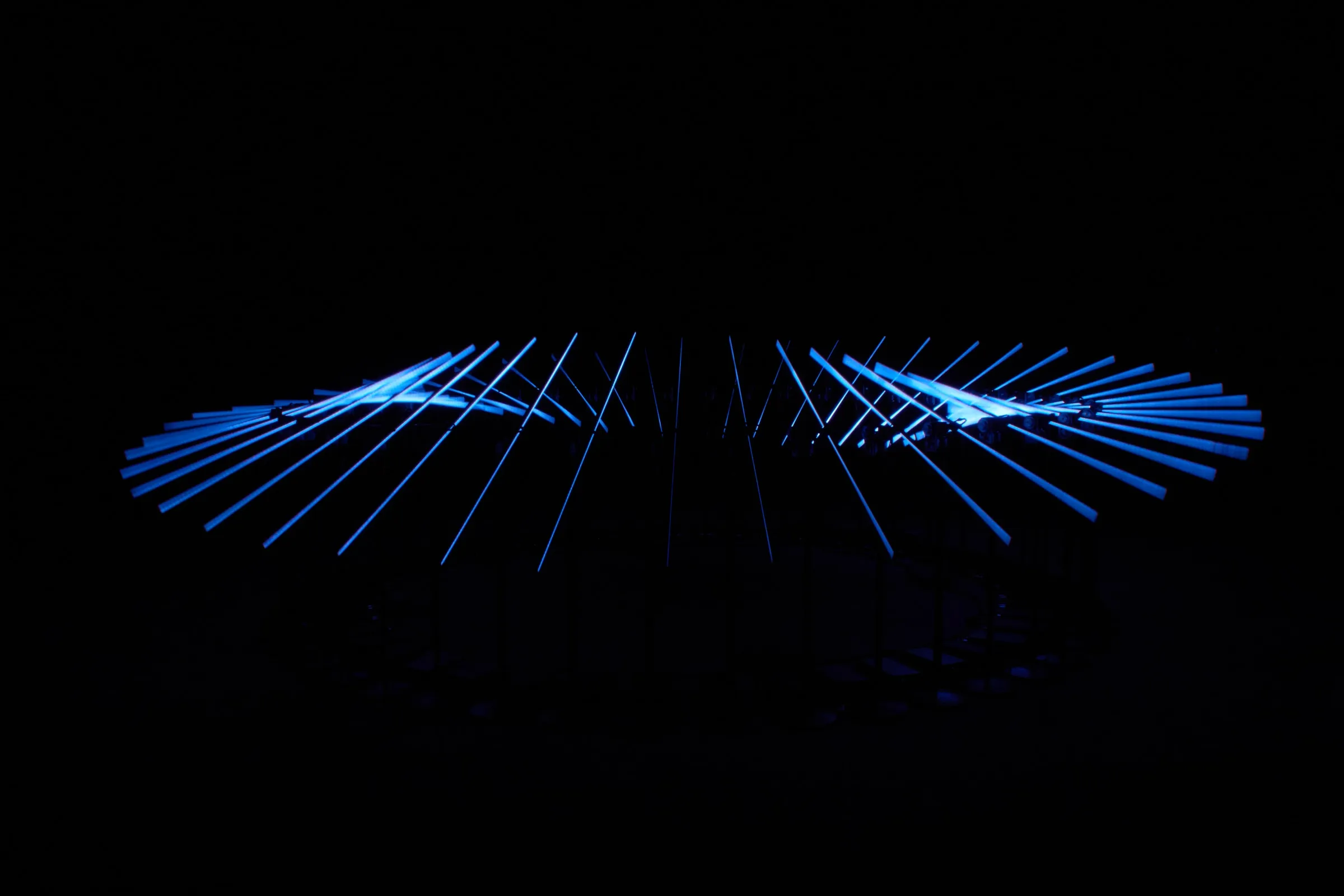 Rods of electric-blue light glowing in the dark